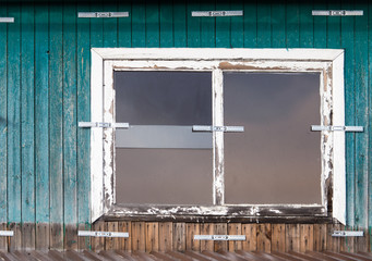 Old wooden windows with houses as background