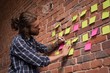 © Wavebreak Media - Male executive writing on sticky note