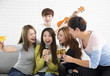 © Tom Wang - young woman holding microphone and singing at karaoke.
