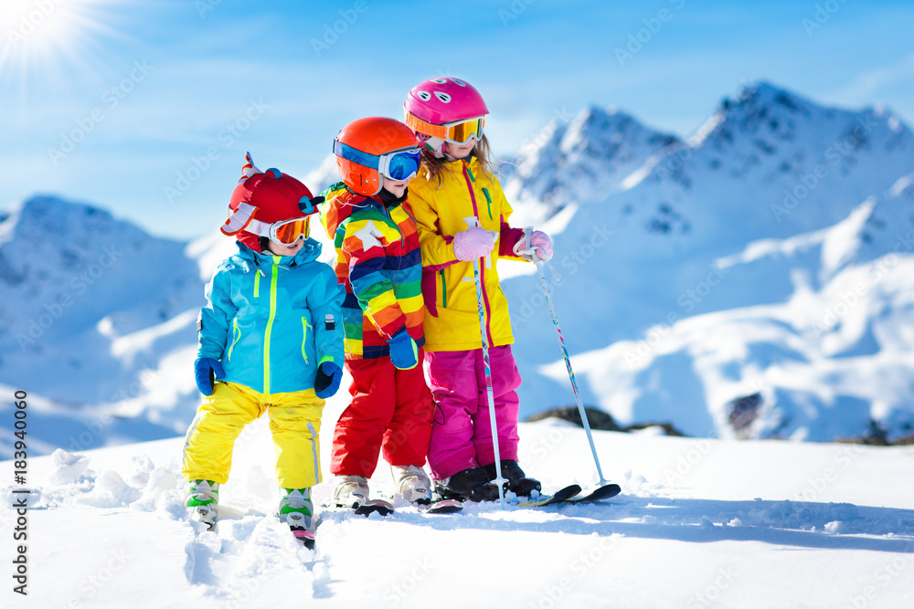 Ski and snow winter fun for kids. Children skiing. - obrazy, fototapety, plakaty 