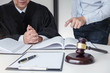 © Freedomz - Close up of gavel, Male lawyer and older judge Consult with client on the case and working with Law books, report the case on table in modern office, Law and justice concept