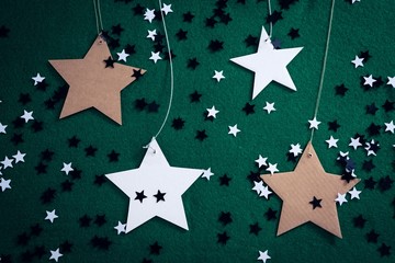 Wall Mural - Handmade stars on green background