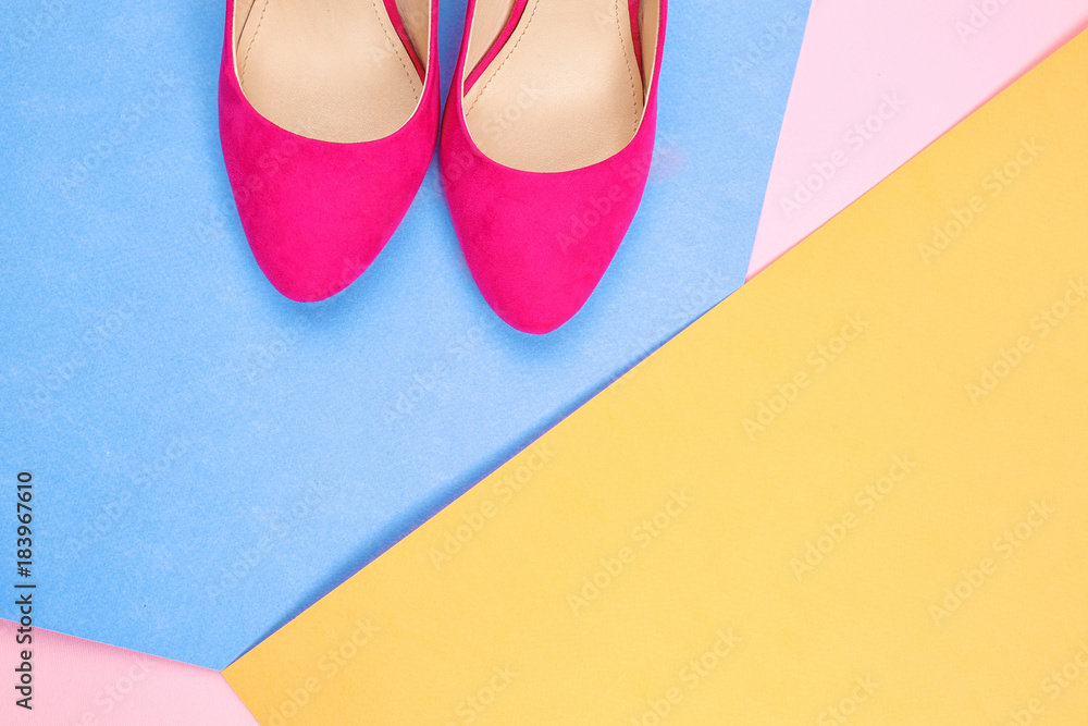 Pair of stylish shoes on color background