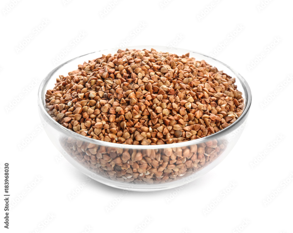 Bowl with raw buckwheat on white background