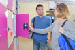 © auremar - young couple standing and talking in locker room