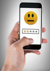 Wall Mural - hand holding phone with two star review medium rating smiley