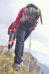 close-up of legs of young hikers walking on the country path. young couple trail waking. focus on hi