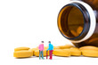 © pookpiik - Miniature people, small figure old man or patient holding walking stick with vitamin C pill or tablets on white background, health care concept.