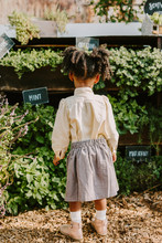 A Little Girl Looking Towards Garden / Plants