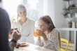 © Lumina/Stocksy - Cute Girl Drinking Juice and Having Breakfast With Her Parents