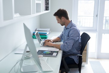 man using laptop at desk