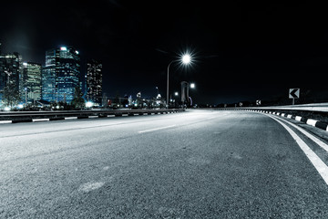 Wall Mural - nigh scene of empty road in modern city