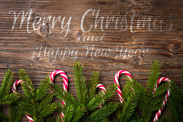 Wall Mural - Christmas wishes with decoration on an old wooden plank