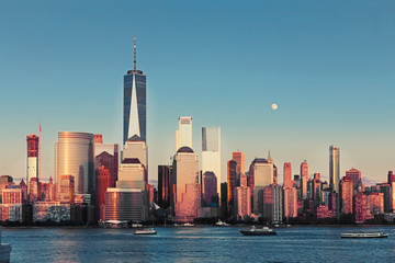 Fototapete - Lower Manhattan Skyline and moon rising at golden hour, NYC, USA