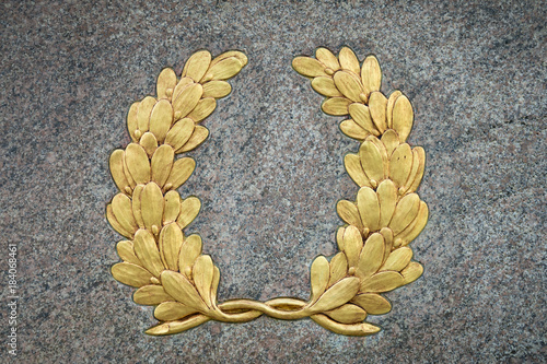Fotografie, Obraz Classic laurel wreath symbol with vintage gold leaf detail on textured raised re