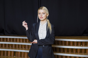 Beautiful blonde businesswoman with puffy lips at loft office in suit. Business concept.