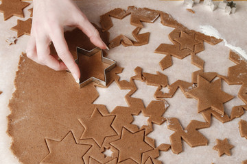 Wall Mural - Woman making gingerbread cookies in star shape.