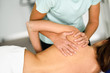Professional female physiotherapist giving shoulder massage to a woman