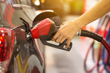 Pumping Gas At Gas Pump. Closeup Of Man Pumping Gasoline Fuel In Car At Gas Station.