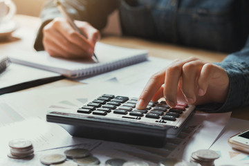 Fototapete - close up hand businesswoman using calculator for calculate finance accounting in office