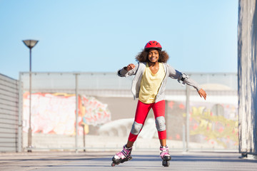 Wall Mural - African girl exercising at outdoor rollerdrom