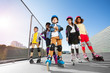 © Sergey Novikov - Happy multiethnic kids in rollerblades  outdoors