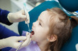 © Ilshat - Child lies in dentist chair and doctor does checkup