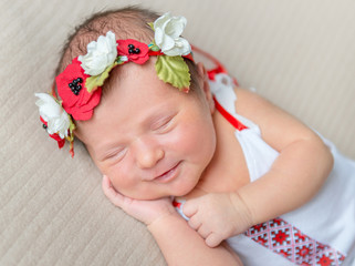 smiling newborn girl in Ukrainain national costume