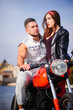 © lanarusfoto - stylish and trendy couple in love on a motorcycle flirting close-up on a background of late autumn in the park