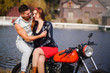 © lanarusfoto - stylish and trendy couple in love on a motorcycle flirting close-up on a background of late autumn in the park