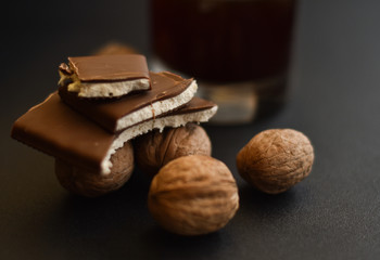 Chocolate and walnuts with coffee on background Organic sweets