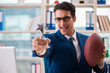 © Elnur - Businessman with american football in office
