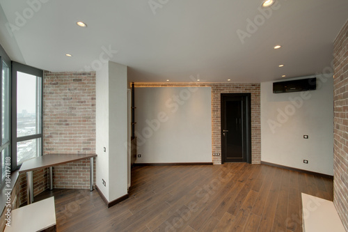 The Room Combined By A Red Brick And White Walls With Dark Doors