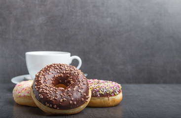 donuts on a grey table with coffee