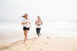 © Maygutyak - two women is jogging the seashore on an overcast day