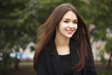 young beautiful brunette girl in the autumn park