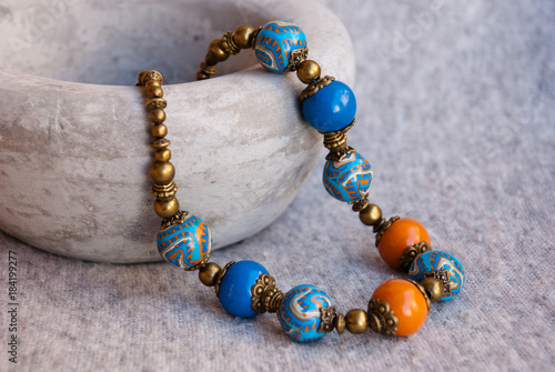 Fotomural Beautiful woman beads in oriental style with ceramic bowl