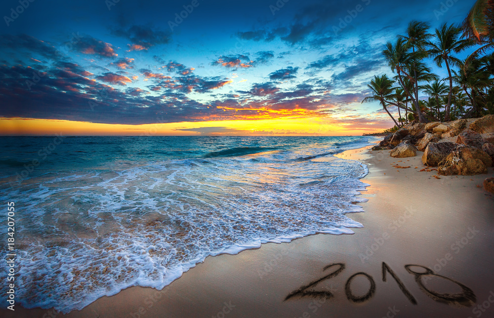 Happy New Year 2018 concept, lettering on the beach. Sea sunrise - obrazy, fototapety, plakaty 