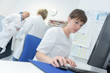 © auremar - female doctor using a computer to write a repport