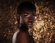 © Raisa Kanareva - portrait of sensual young african woman against golden background