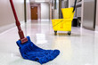 Mopping wet floor in hallway