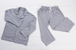 © DenisProduction.com - Boys' pajama set on white. Soft gray melange cotton. Loose-fitting shirt and pants for comfort rest at night.