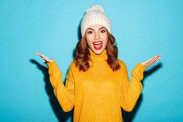 Wall Mural - Portrait of a happy young girl dressed in winter clothes