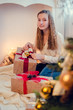 © Nelli Kovalchuk - Teenage girl opening the present