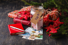 Save Money For Christmas Gift Concept With Glass Jar