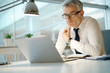 © goodluz - Businessman working on laptop in office, being concerned