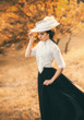 © kharchenkoirina - Exquisite lady in a vintage dress in a beautiful hat walks among the hills, against the background of wild nature. Artistic Photography