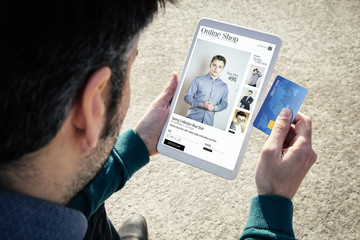 Canvas Print - shopping clothes online on a tablet with credit card