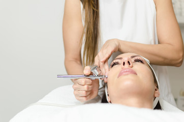 girl enjoying in oxygen treatment face skin in beauty spa