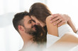 © LIGHTFIELD STUDIOS - young couple smiling and embracing in bed in morning